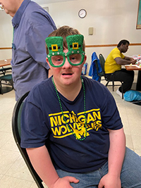 Man with I/DD wearing St. Patty glasses