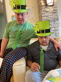two men with I/DD wearing green