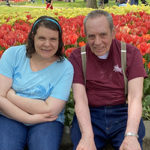 man and woman near tulips