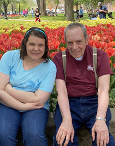 man and woman near tulips