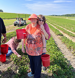 Women with disabilities in a berry field