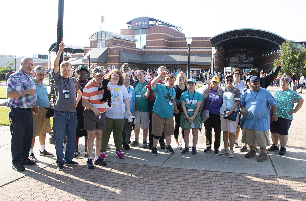 a group of people outside a ball park