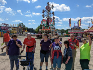 a group of adults at a fair