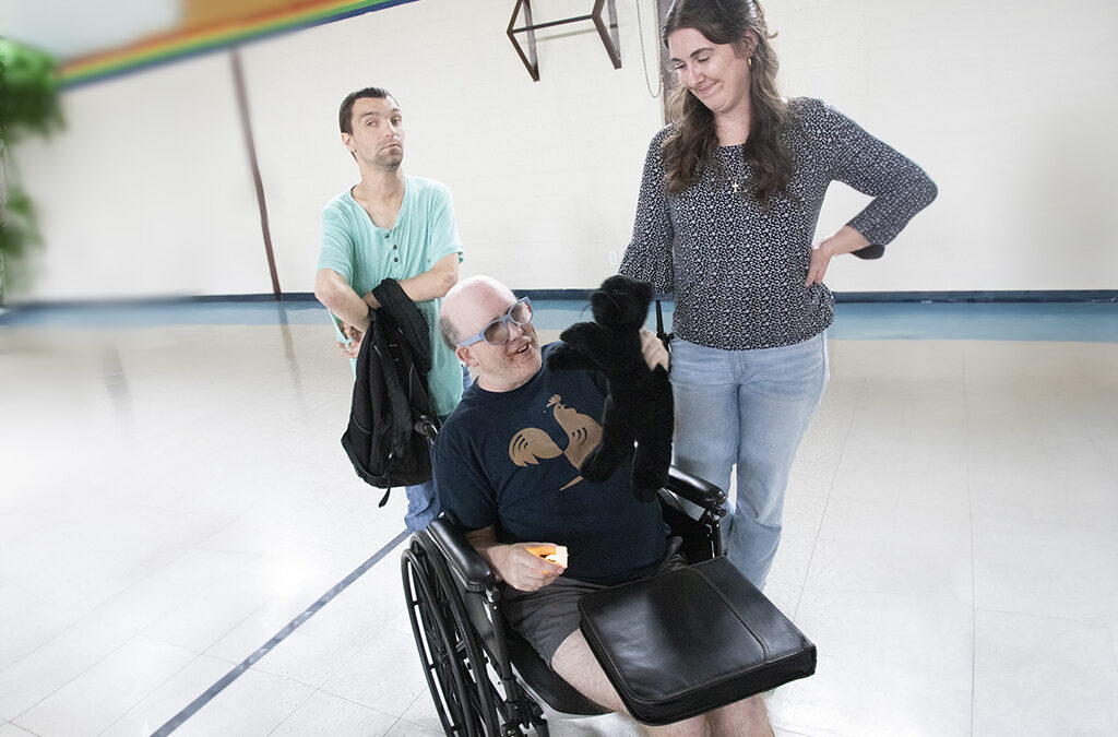 A woman chatting with a man in a wheelchair