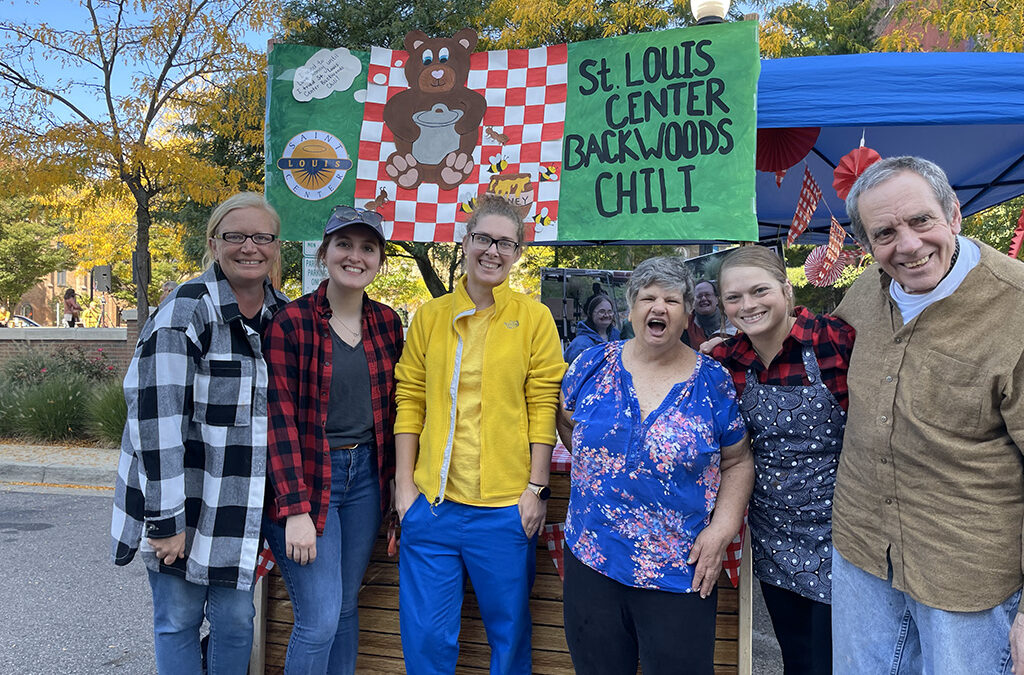 A happy group of Adults at a Chili cook off