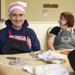 Man with developmental disabilities in a clay class