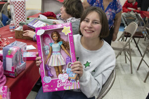 A female resident of St. Louis Center is happy to show off her Christmas present.