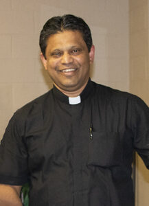 Fr. Satheesh Alphonse wearing a Roman collar