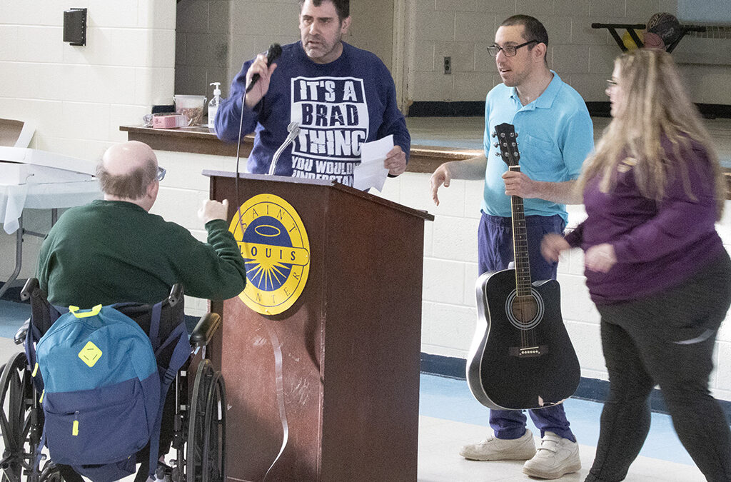 St. Louis Center Staff and residents at the podium