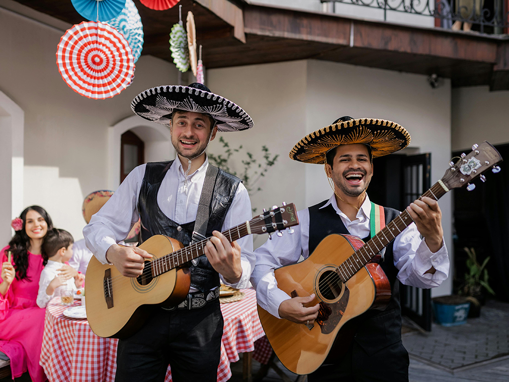 A Latino Mariachi band performing on a veranda.