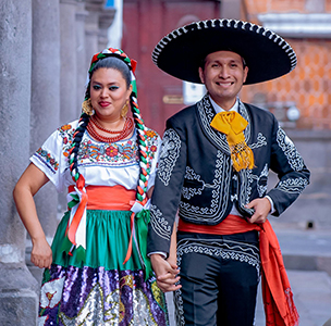 A woman and man in traditional Spanish cosutmes.