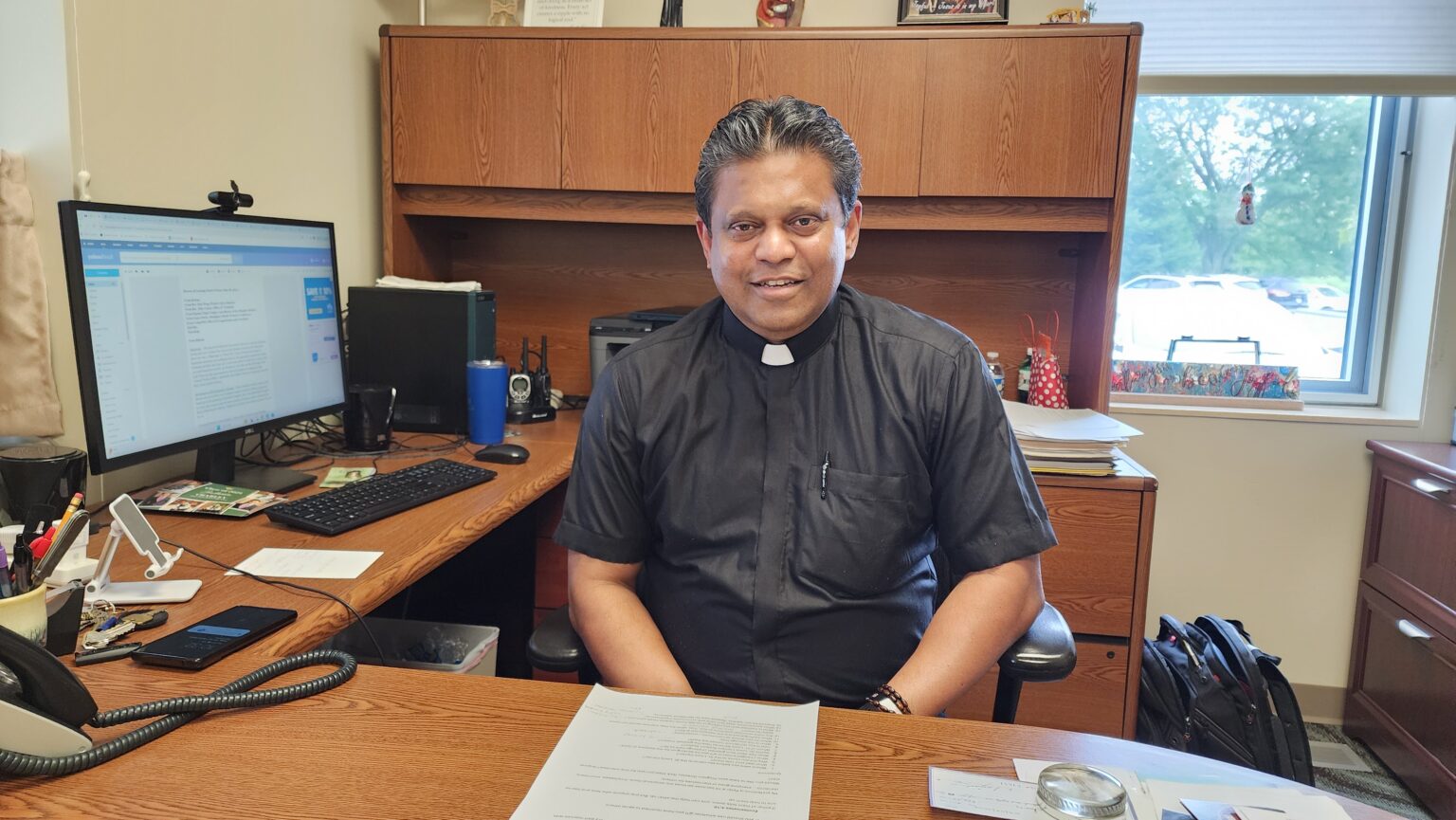 Fr Satheesh at his desk