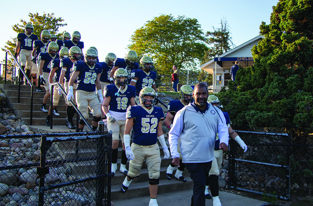 Lee Chambers leads the CHS football team onto the field